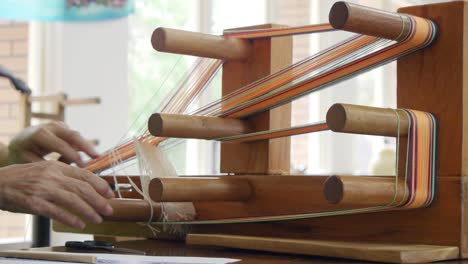 Yarn-being-looped-onto-traditional-Asian-wooden-loom