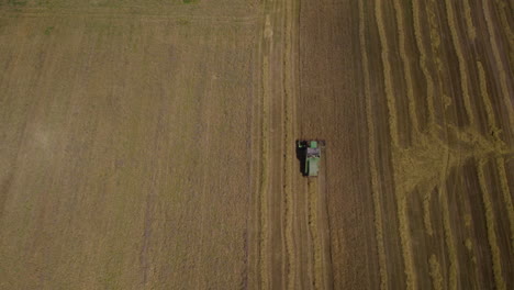 A-tractor-slowly-harvests-crops-aerial-drone-Farm