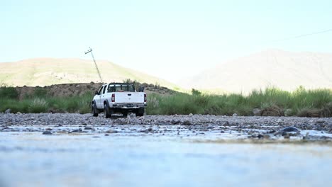 View-Of-Parked-White-Truck-Across-Flowing-River