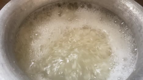 Rice-Being-Cooked-In-Pot-With-Boiling-Water