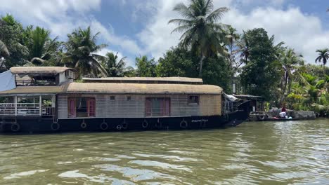 Houseboat-Docked-On-Tropical-Kumarakom-River-Banks-In