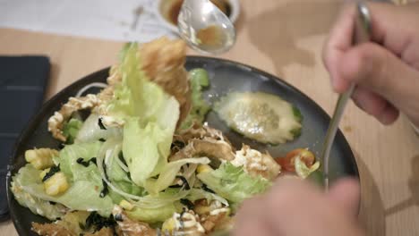 using-spoon-and-fork-picking-salad-with-fried