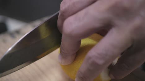 using-knife-to-cut-fresh-lemon-on-the