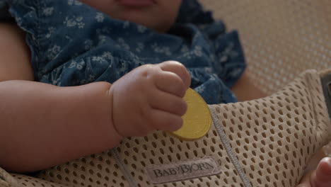 Cute-baby-holding-a-Bitcoin-whilst-rocking-in