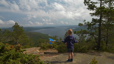 Boy-waving-Swedish-flag-atop-Skuleberget-mountain-overlooking