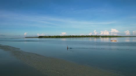local-fisherman-walking-in-shallow-water-at-low