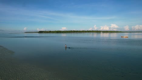 fisherman-walking-in-shallow-water-at-early-morning