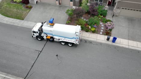 Drone-shot-of-a-recycling-truck-pulling-up