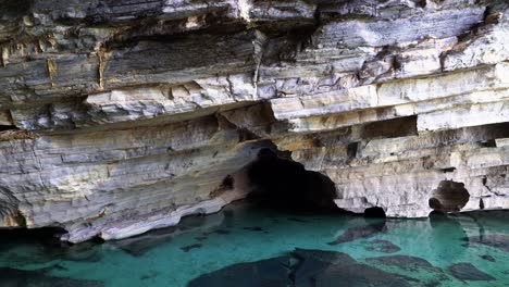 Tilting-down-shot-revealing-a-stunning-grey-cave