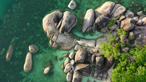 aerial-top-down-of-large-boulders-on-shore