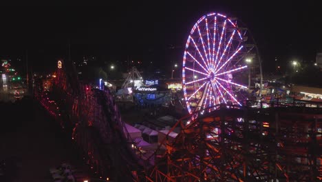 Ferris-Wheel-And-Roller-Coaster-Ride-At-Night
