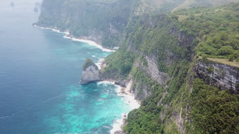 Dramatic-aerial-tilt-reveals-steep-rocky-cliffs-in