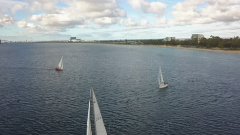 Sailboats-form-single-line-as-they-navigate-through