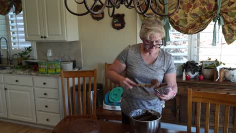 Homemaker-filling-an-icing-bag-with-chocolate-frosting