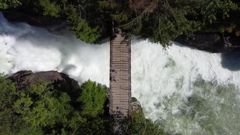 Ascending-aerial-showing-powerful-river-passing-below-small