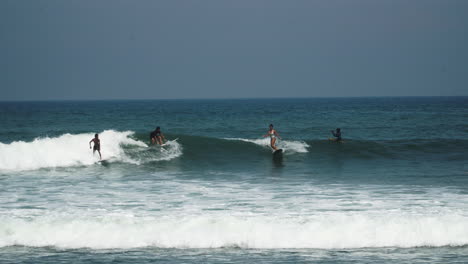 Beach-scene-with-surfers-surfing-waves-in-Bali
