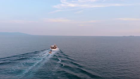 Aerial-Panning-Shot-Following-Wooden-Fishing-Boat-Cruising