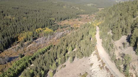 Aerial-reveal-of-a-dirt-road-leading-towards