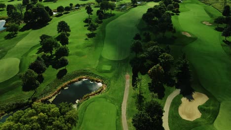 Aerial-drone-forward-moving-shot-over-a-green