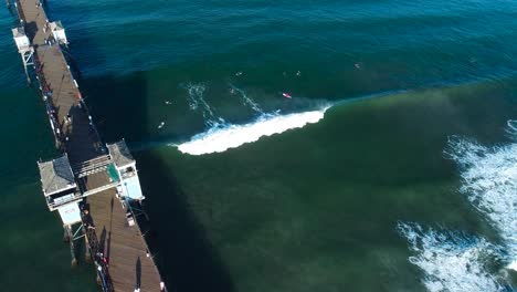 Arial-shot-of-oceanside-pier-and-surfers-with
