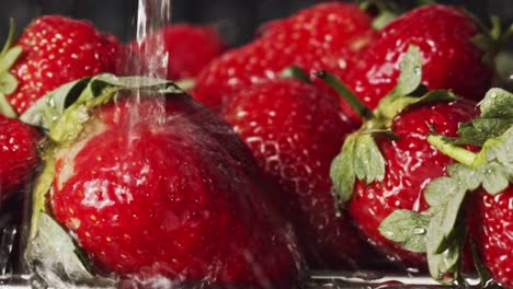 Water-splashing-onto-red-strawberries