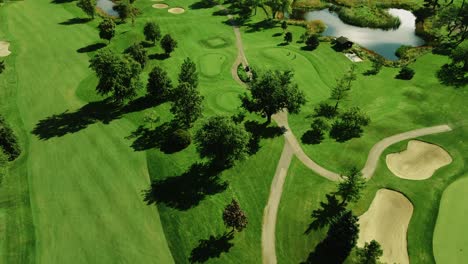 Aerial-drone-tilt-up-shot-of-green-golf