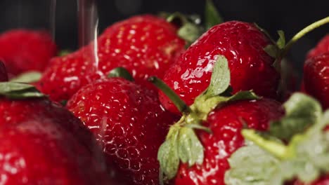Water-droplets-splashing-onto-red-strawberries