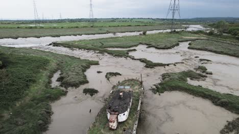 Aerial-View-of-Wooden-Boat-in-Mud-Stranded