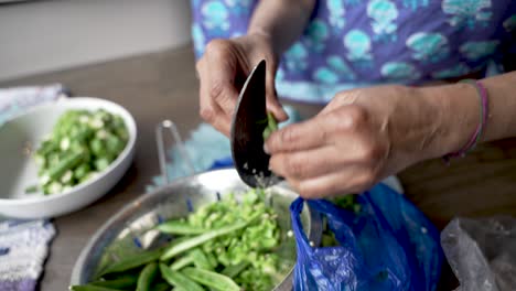 Weathered-Hands-Of-Women-Cutting-Greens-Beans-Using