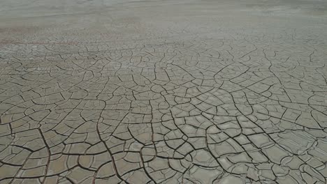 Cracked-wet-and-muddy-grey-surface-of-the