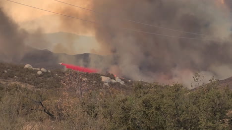 Airplane-Drops-Red-Fire-Retardant-on-Wildfire-in