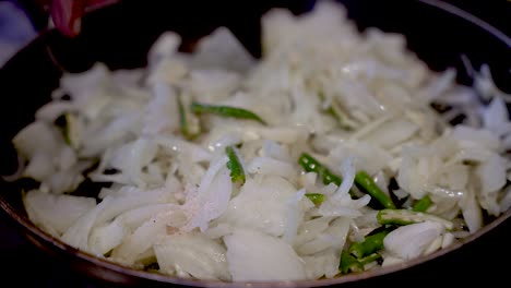 Stirring-Fresh-Sliced-White-Onions-In-Saucepan-With