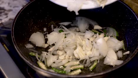 Fresh-Sliced-White-Onions-Being-Dropping-Into-Sizzling