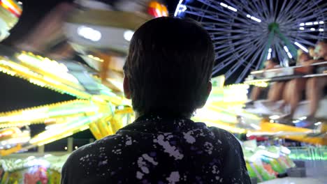 A-young-boy-watches-the-rides-at-an