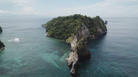Aerial-to-rugged-rocky-Batupadasan-Island-on-Nusa