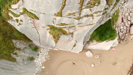 Top-down-shot-over-a-cliff-showing-people-relaxing