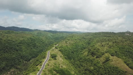 Aerial-tracks-moto-on-isolated-jungle-mountain-ridge