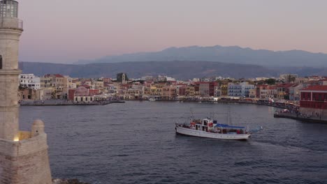 Aerial---Lighthouse-of-Chania-Greece-with-large-boat
