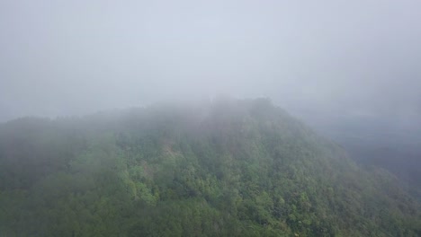 aerial-shot-of-cloudy-hill-and-forest-K