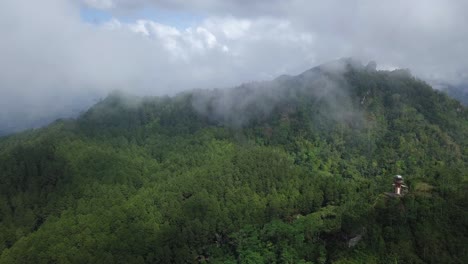 Forward-drone-video-of-rain-forest-and-hill