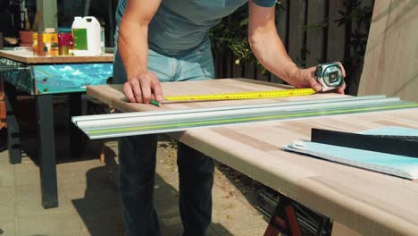 male-carpenter-use-measuring-tape-ruler-to-measure