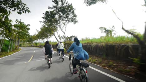 Group-of-woman-riding-bicycles-on-countryside-road