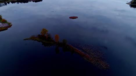 Aerial-drone-backward-moving-shot-over-large-lake