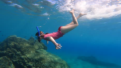 a-young-girl-doing-scuba-diving-dives-underwater