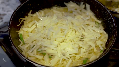 Thin-Sliced-Potatoes-Pieces-Being-Sprinkled-Onto-Frying