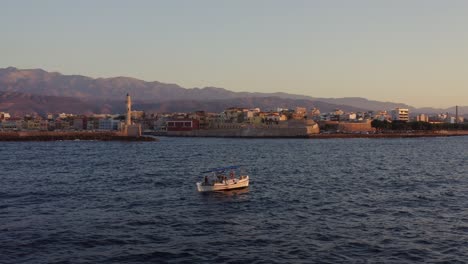 Aerial---Small-fishing-boat-floating-in-Chania-Greece