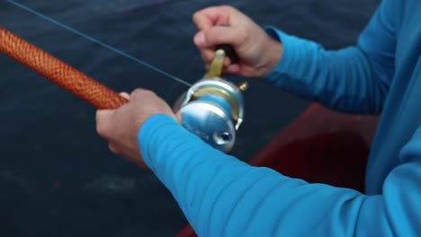 Winding-a-conventional-fishing-reel-in-slow-motion