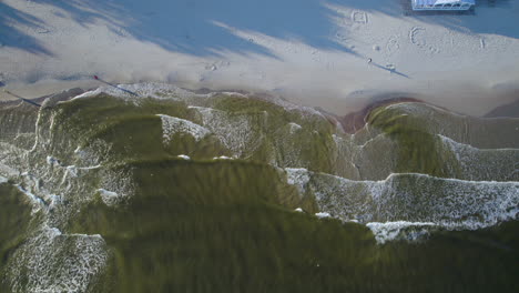 Top-Down-View-Of-Waves-Splashing-On-Sandy