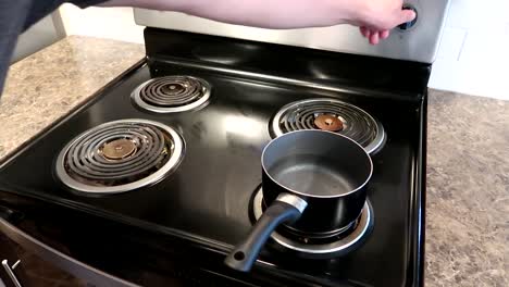 Placing-a-small-pot-to-boil-water