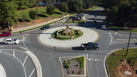 Backwards-aerial-of-roundabout-with-heavy-traffic-in